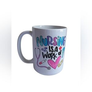 "Nursing Is A Work Of" White Mug